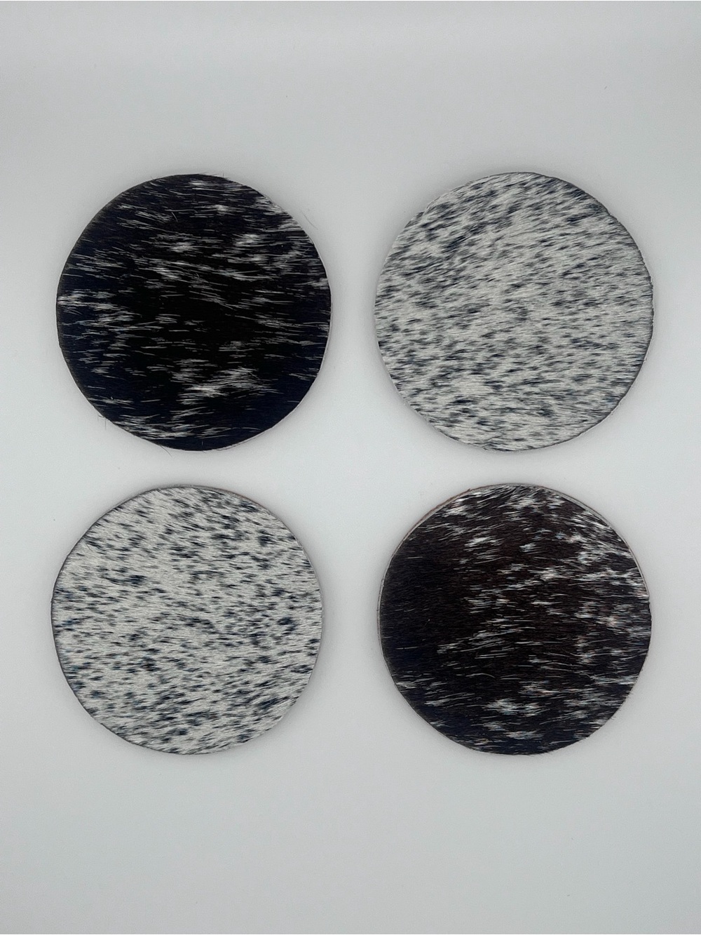 Set of 4 Round Cowhide Coasters in Black and White